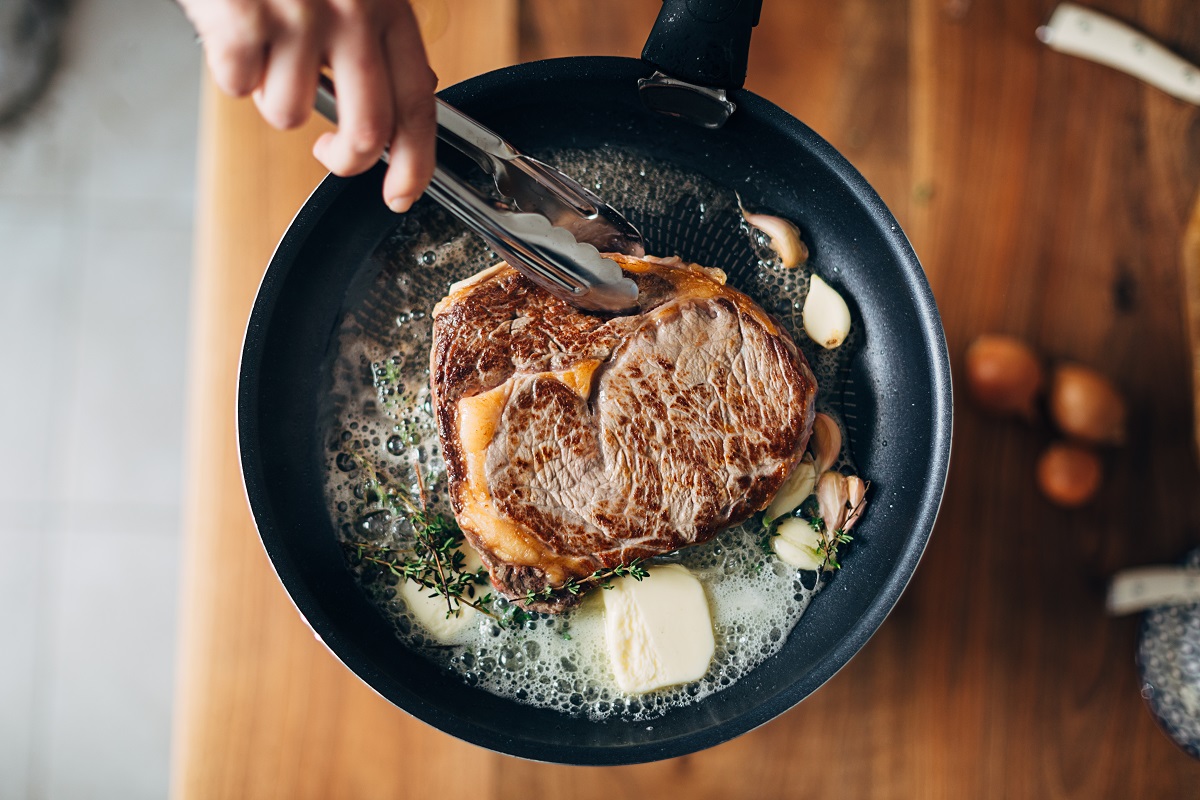Overhead,Shot,Of,Chef,Preparing,Ribeye,With,Butter,,Thyme,And
