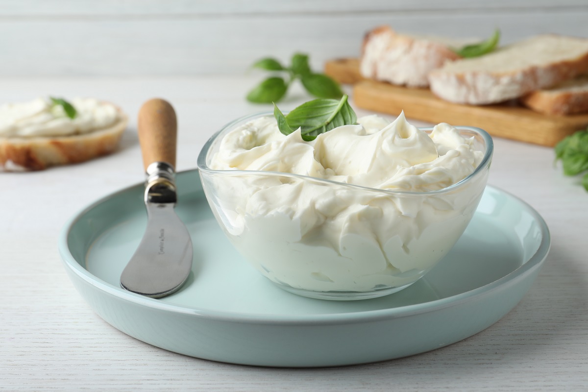 Tasty,Cream,Cheese,With,Basil,And,Knife,On,White,Wooden