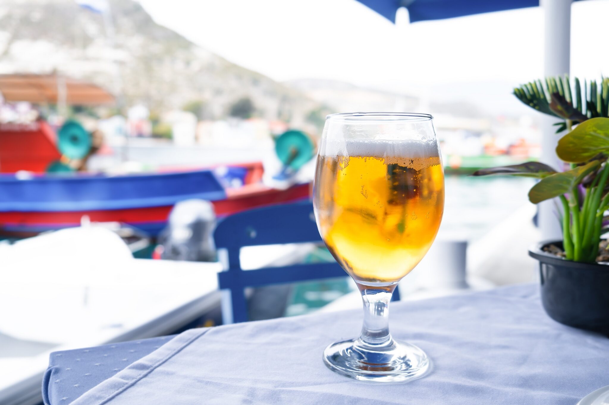 Glass,Of,Beer,At,Table,Over,A,Sea,At,Background,