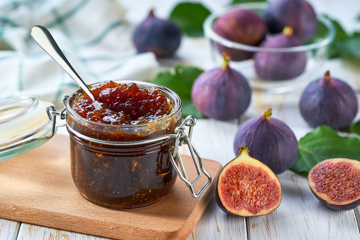 Jar,Of,Tasty,Figs,Jam,On,A,White,Wooden,Table.