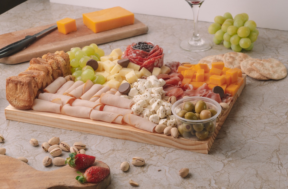 Cheese,Platter,On,A,Marble,Table,With,Fruit,And,Wine