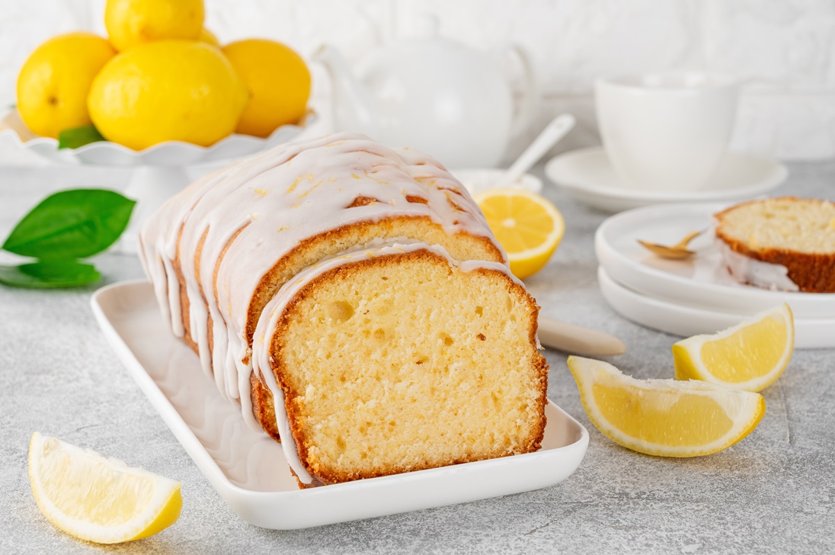 Lemon,Loaf,Cake,With,Sugar,Icing,On,A,White,Plate
