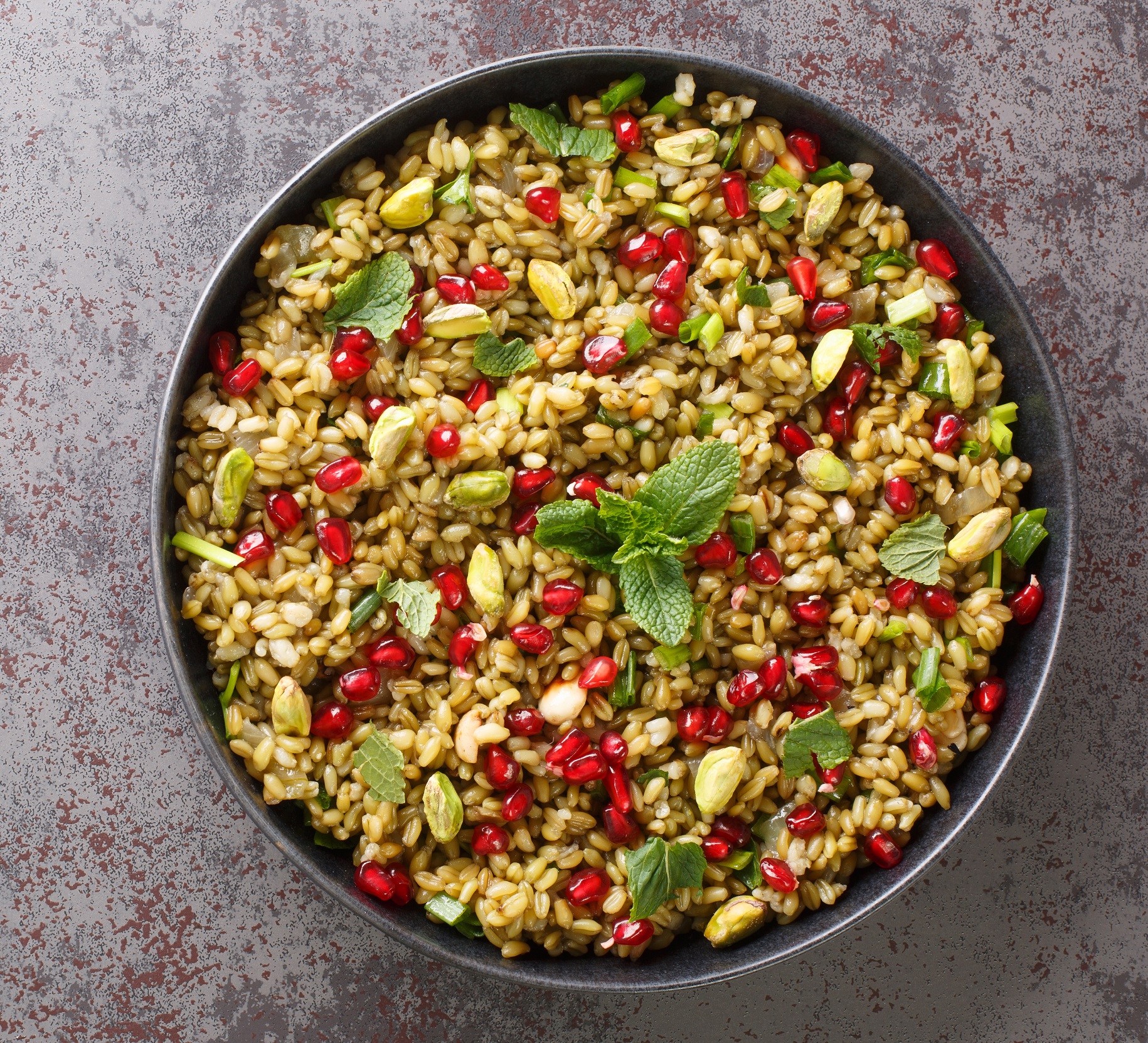 Delicious,Vegetarian,Freekeh,With,Pomegranate,,Nuts,And,Herbs,Close-up,In