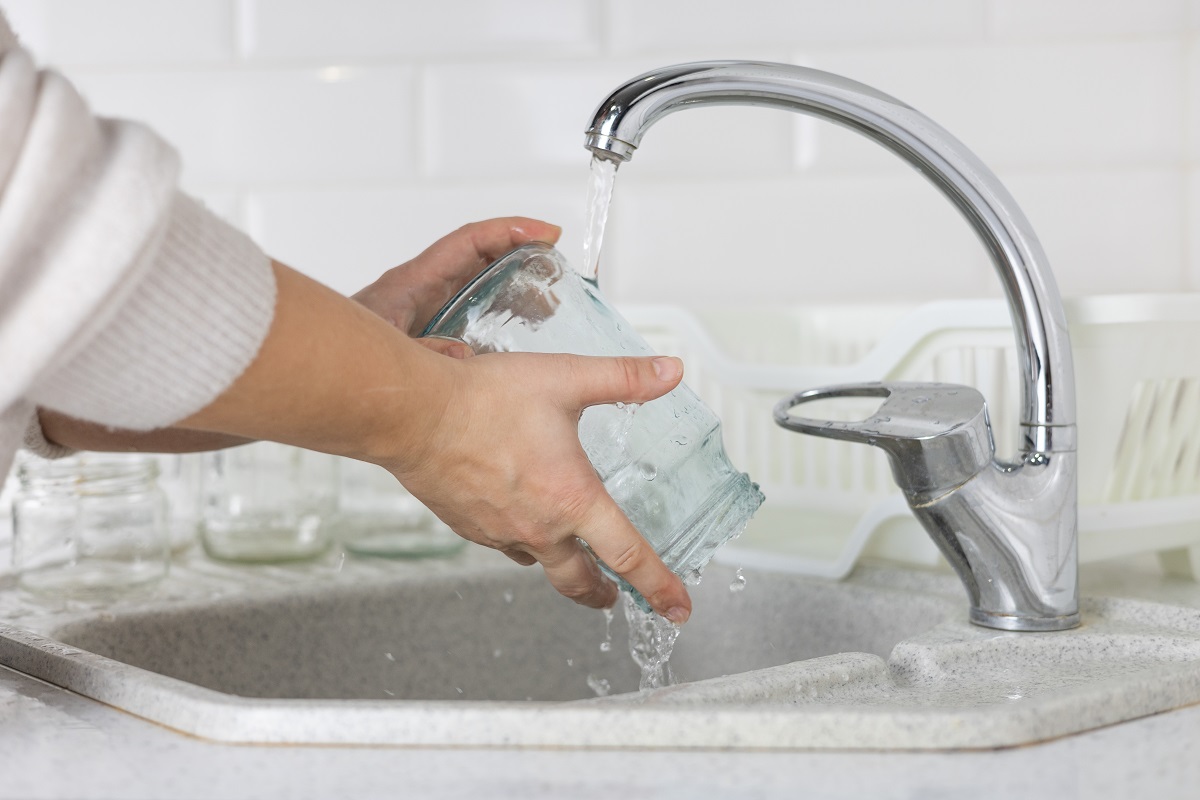 In,The,Kitchen,Sink,,A,Woman,Under,The,Tap,Washes