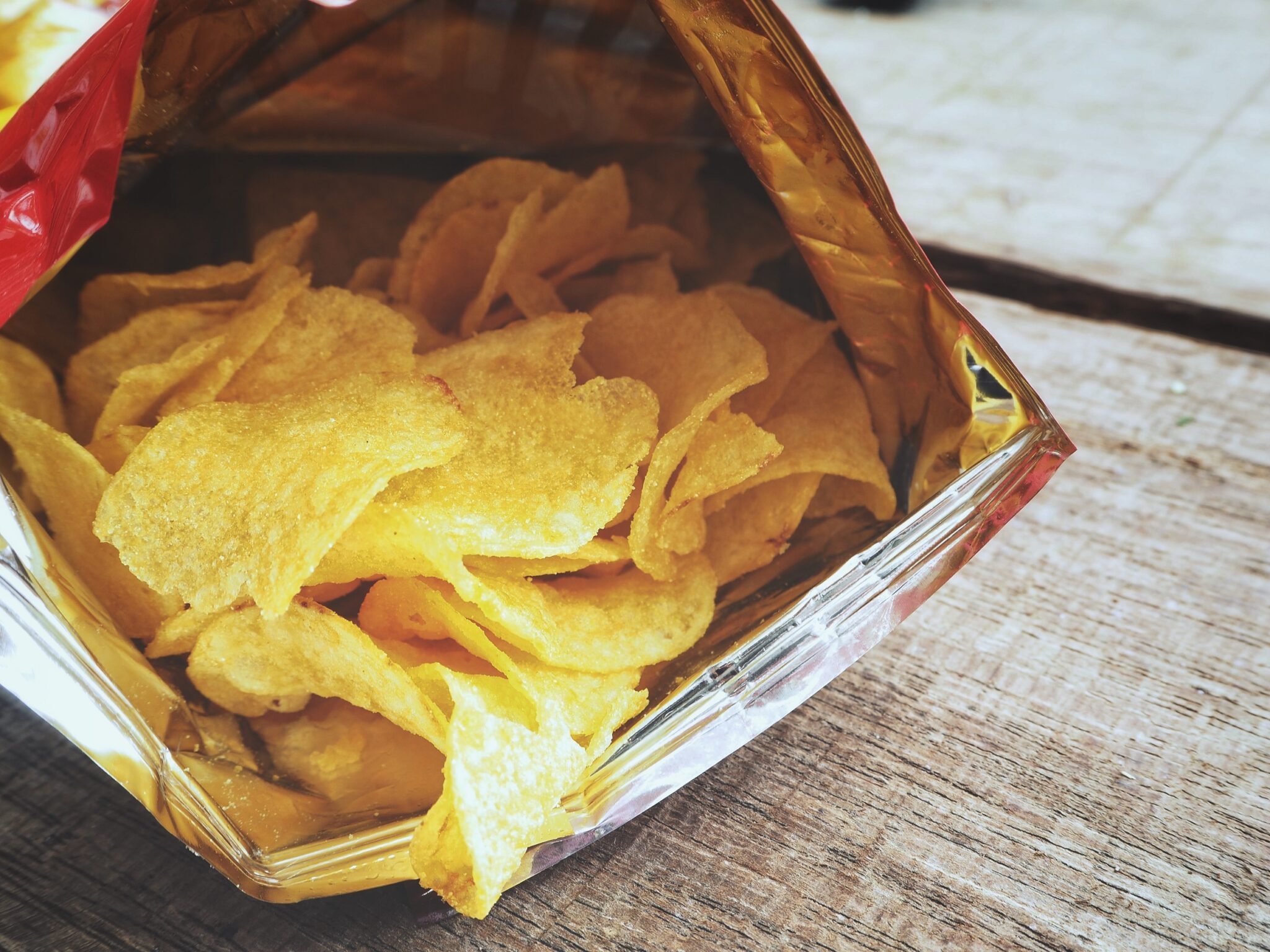 Potato,Chip,On,Wood,Background