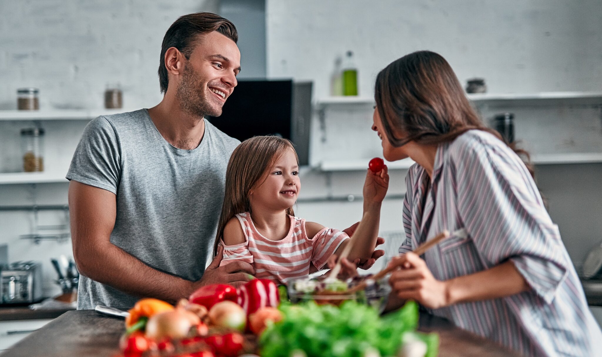 Mom,,Dad,And,Daughter,Are,Cooking,On,Kitchen.,Happy,Family
