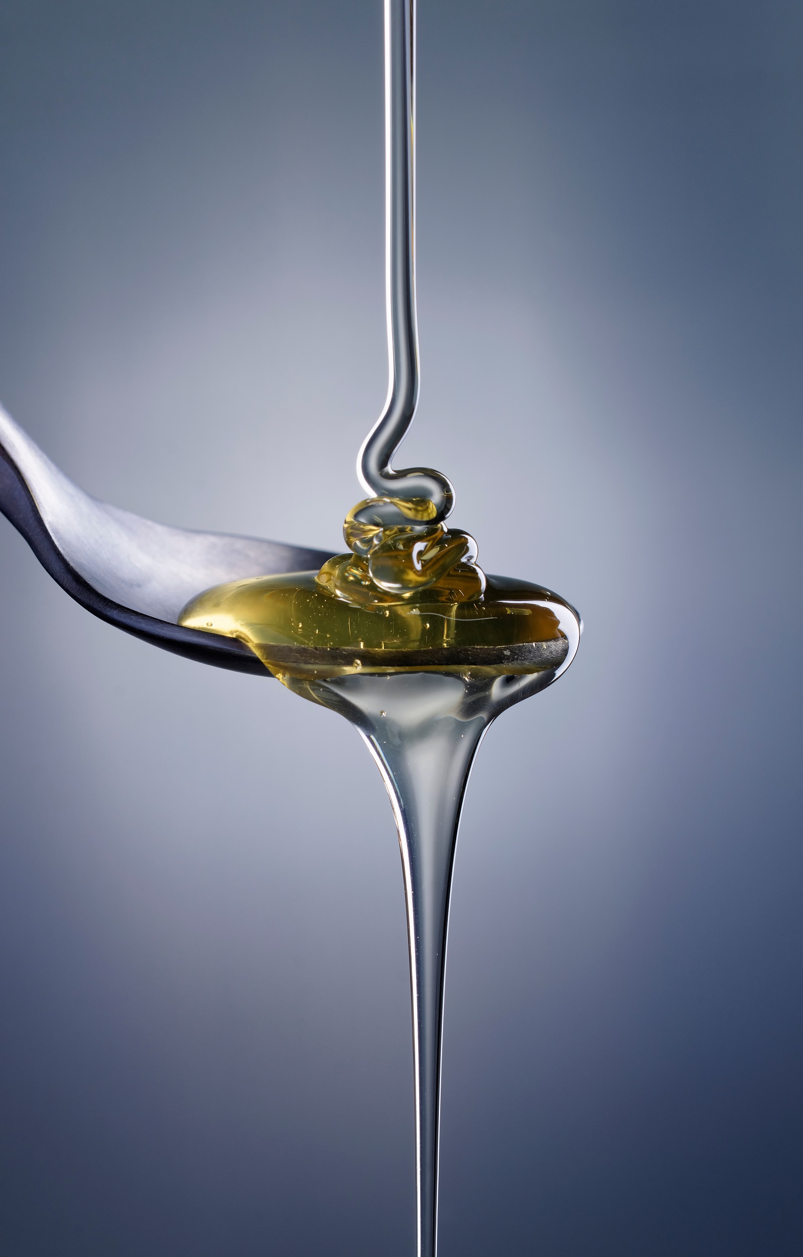 Food;,Studio,Still,Life,Of,Honey,Poured,In,A,Teaspoon