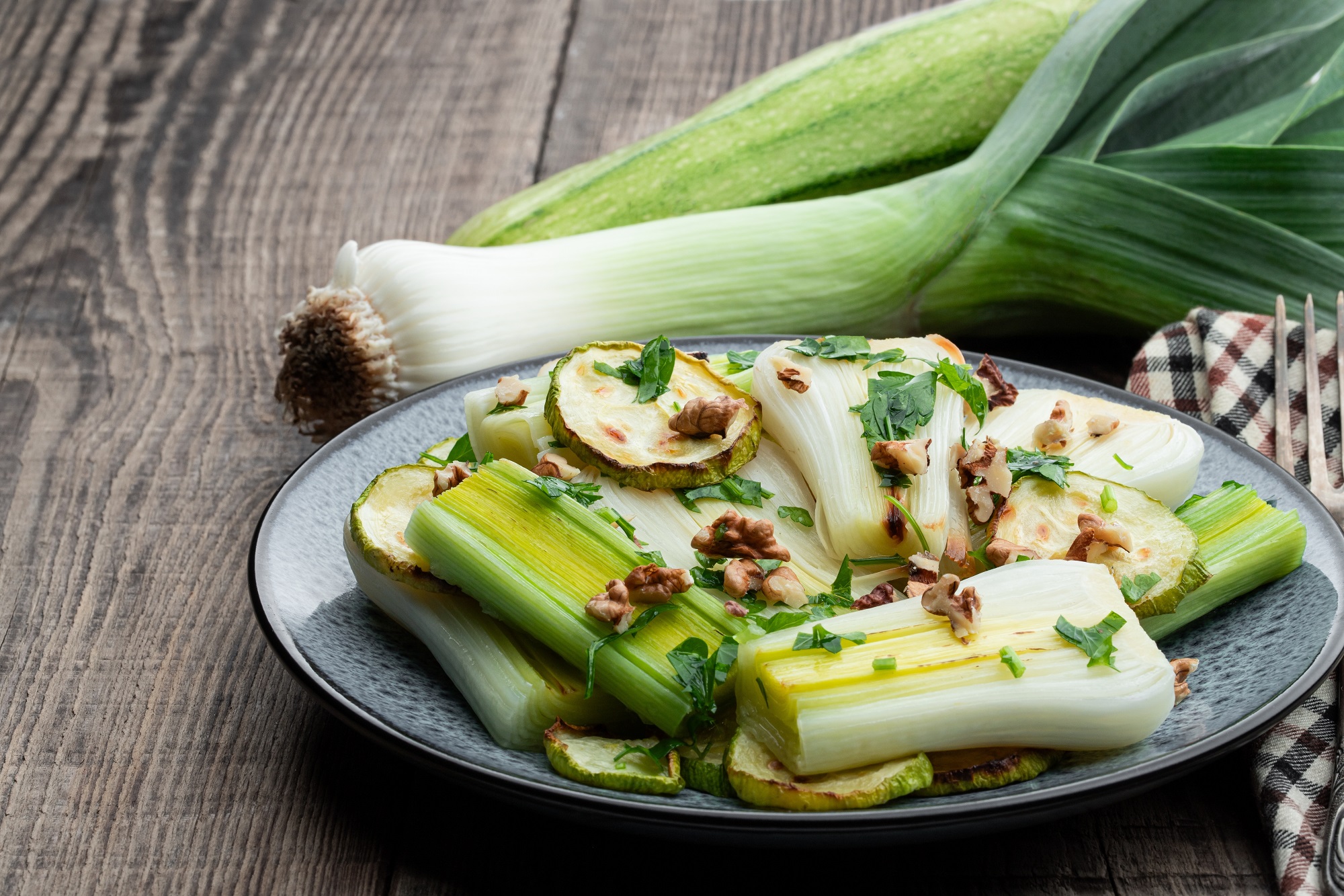 Roasted,Leeks,And,Zucchini,With,Nut,And,Herbs,On,Wooden