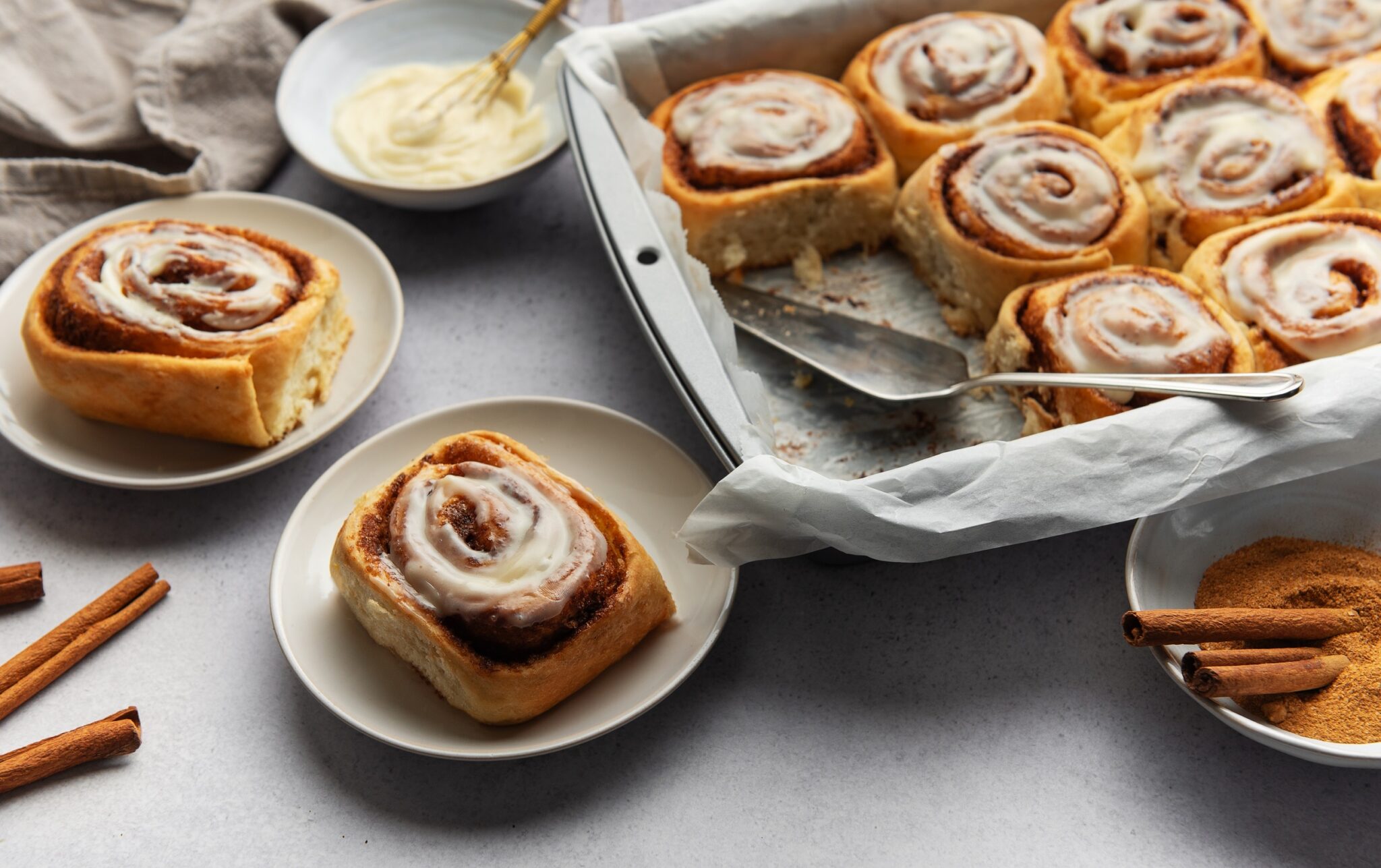 Delicious,Cinnamon,Rolls,,Served,On,Plates,And,In,A,Baking