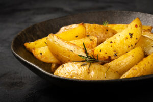 Roasted,Potatoes,With,Rosemary,On,The,Plate.