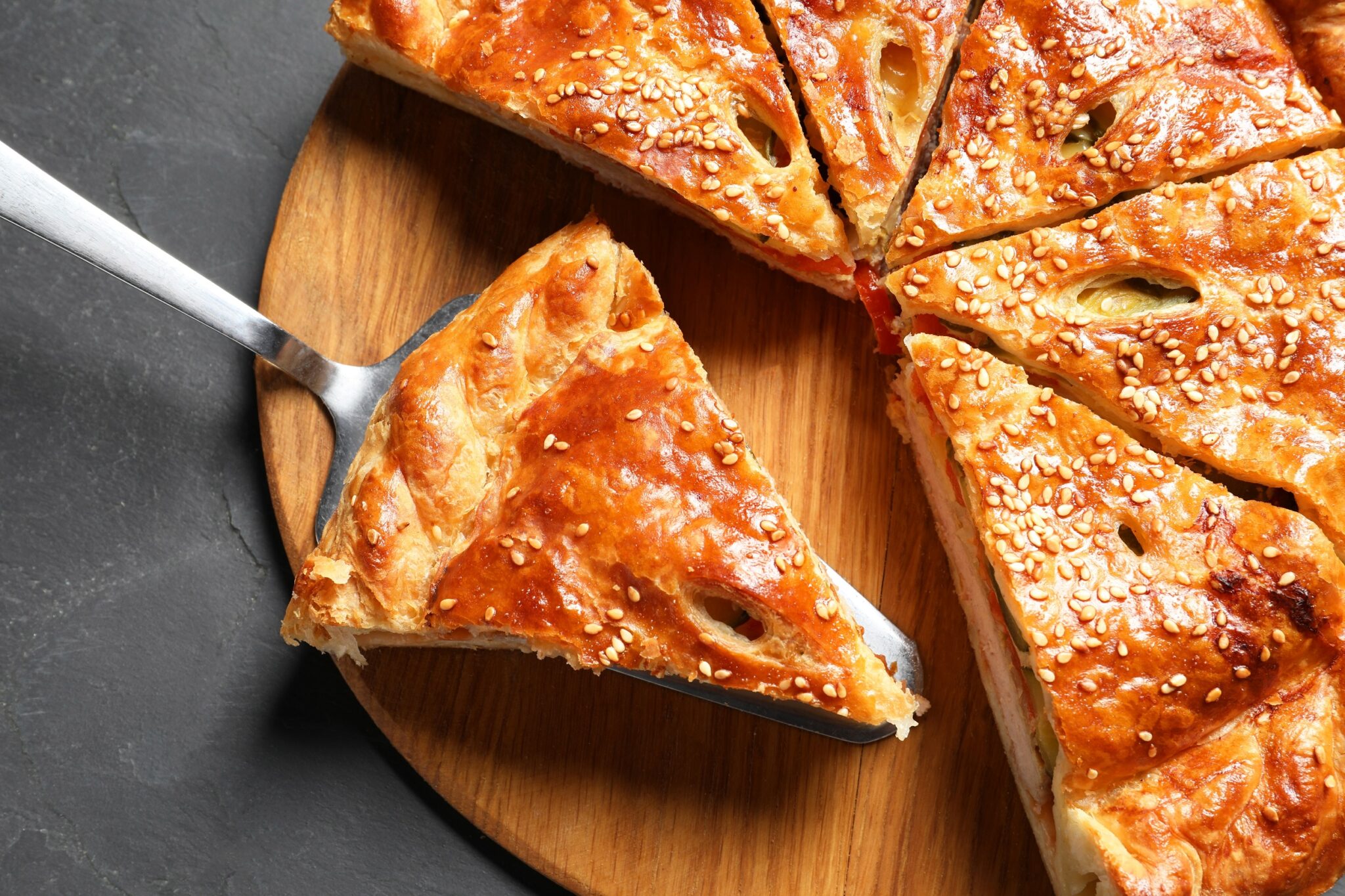 Cut,Delicious,Homemade,Pie,And,Server,On,Black,Table,,Top