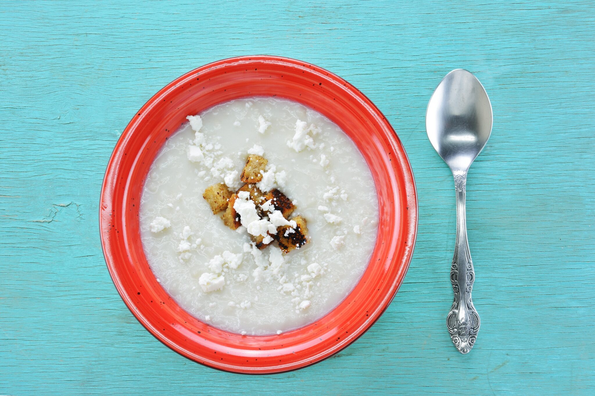 Trahana,Soup,With,Feta,And,Crouton,On,Turquoise,Wooden,Table