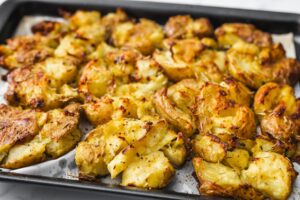 Smashed,Baby,Potatoes,On,Oven,Tray,With,Rosemary,And,Herbs,