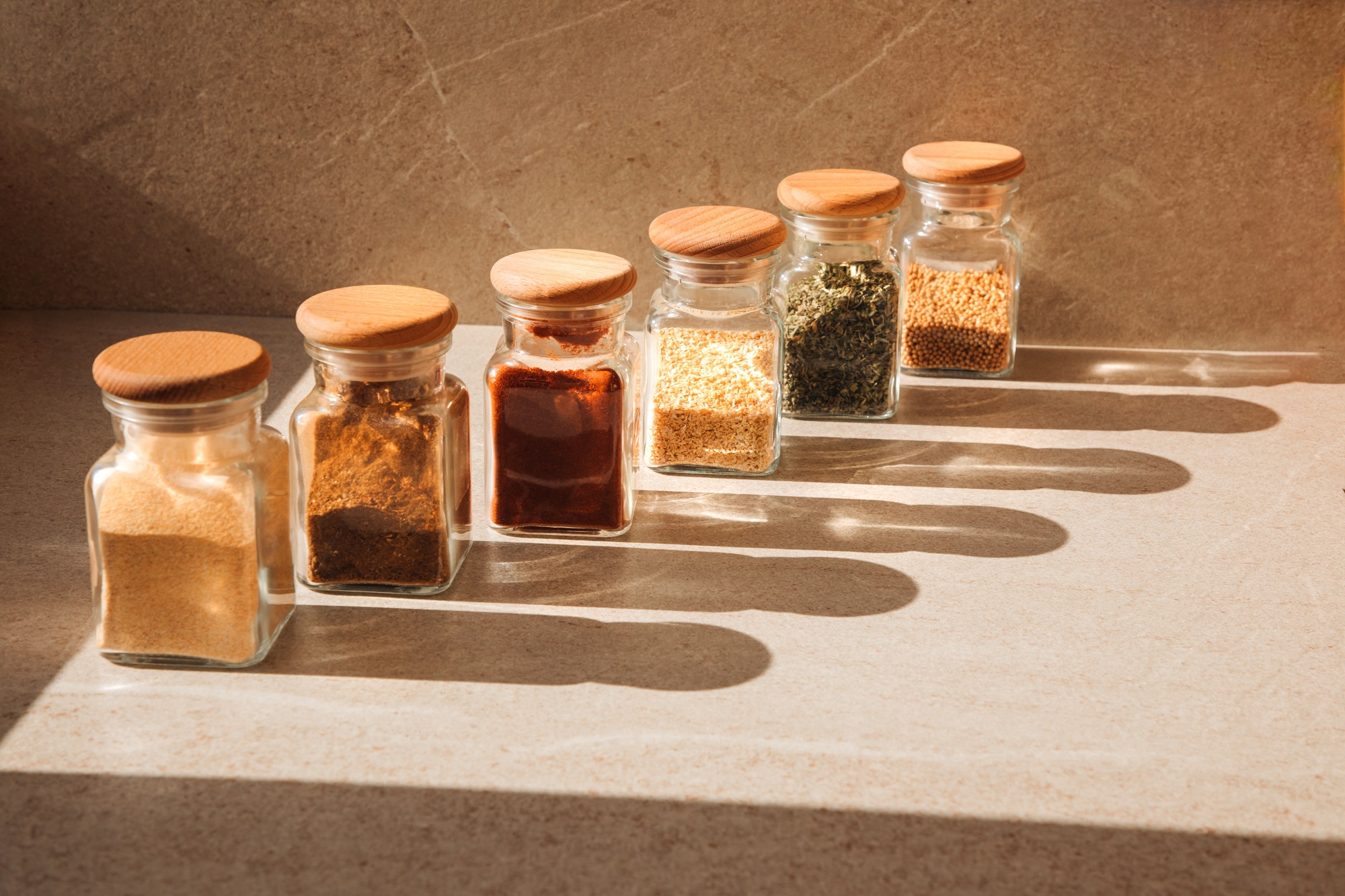 A,Group,Of,Seasoning,In,Glass,Jars,On,A,Light